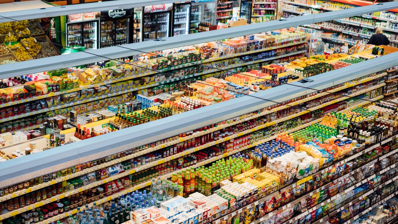 Packed supermarket aisles stocked with grocery products